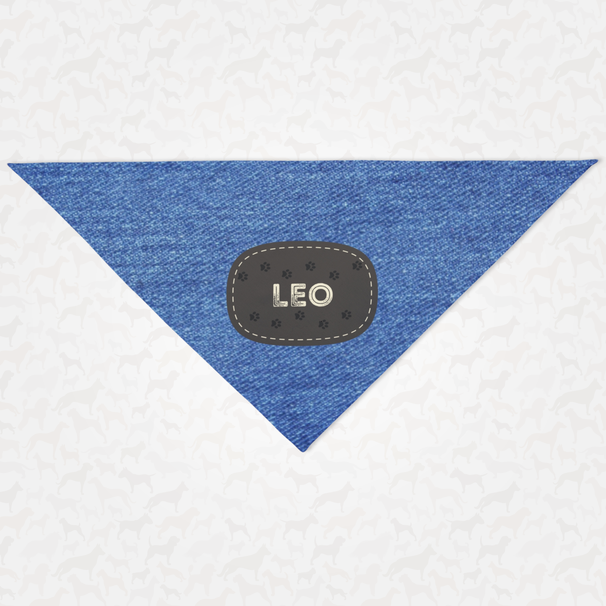 Personalized dog bandana featuring name on paw trail badge with denim print effect background.